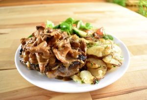 Ribeye with chanterelles, potatoes Lyonnsaise and a salad