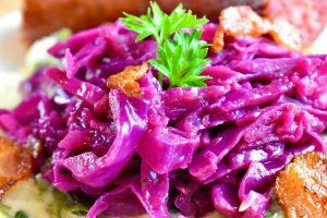 braised red cabbage and apple with a sprig of parsley on top